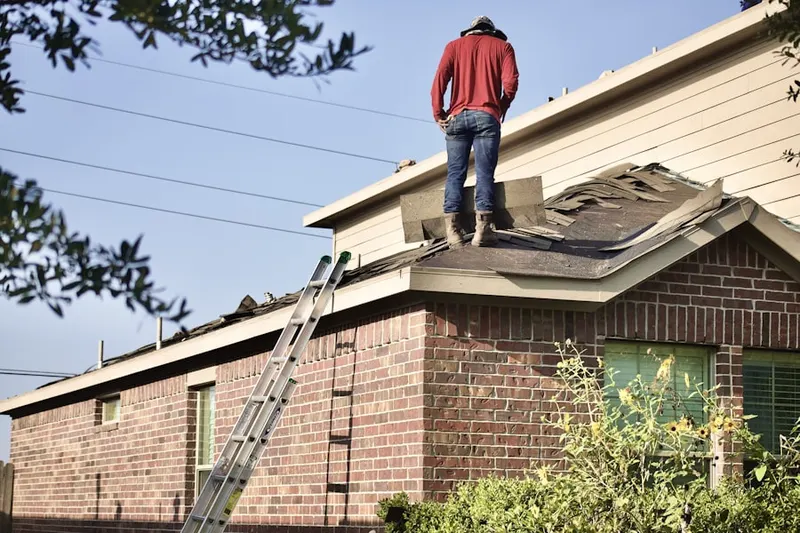 Professional roofer working on a residential roof in Downtown East